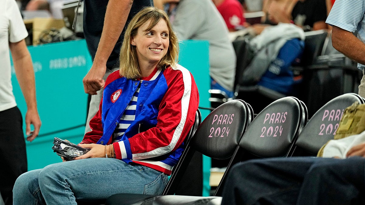 Katie Ledecky takes in a basketball game