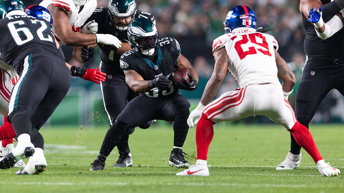 Boston Scott carries the ball during a game