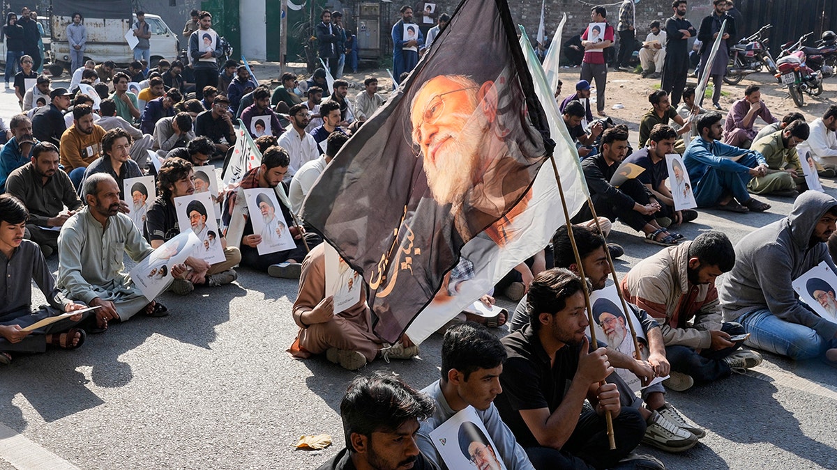 Protesters holding a flag of Khamenei.