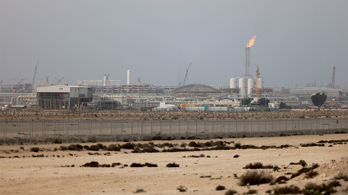 Industrial energy infrastructure with processing units and storage tanks at a major Qatari gas complex following a production shutdown.