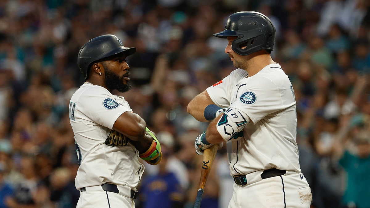 Randy Arozarena and Cal Raleigh reacts on field