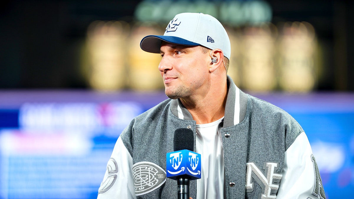 Rob Gronkowski smiles while visiting the "Thursday Night Football" on Prime set at Gillette Stadium before an NFL game.