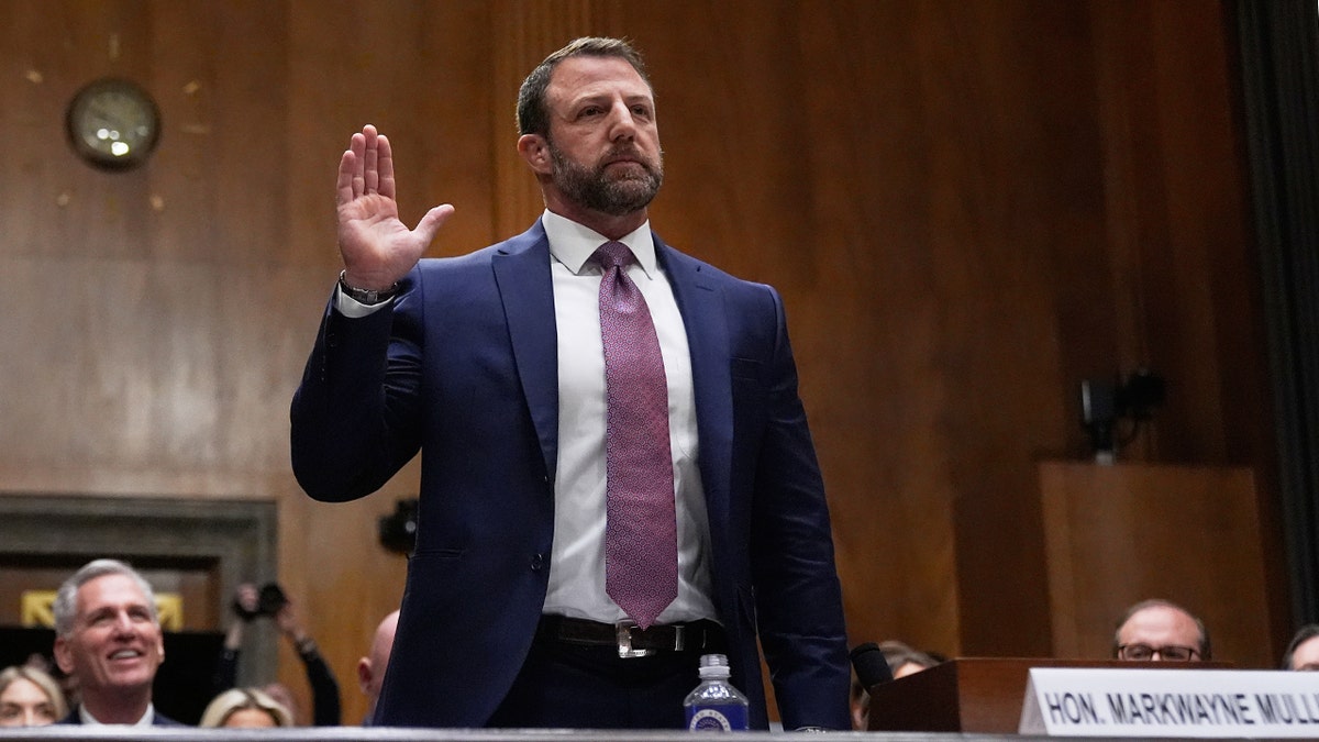 Markwayne Mullin being sworn in before testifying during a Senate Committee hearing on Capitol Hill.