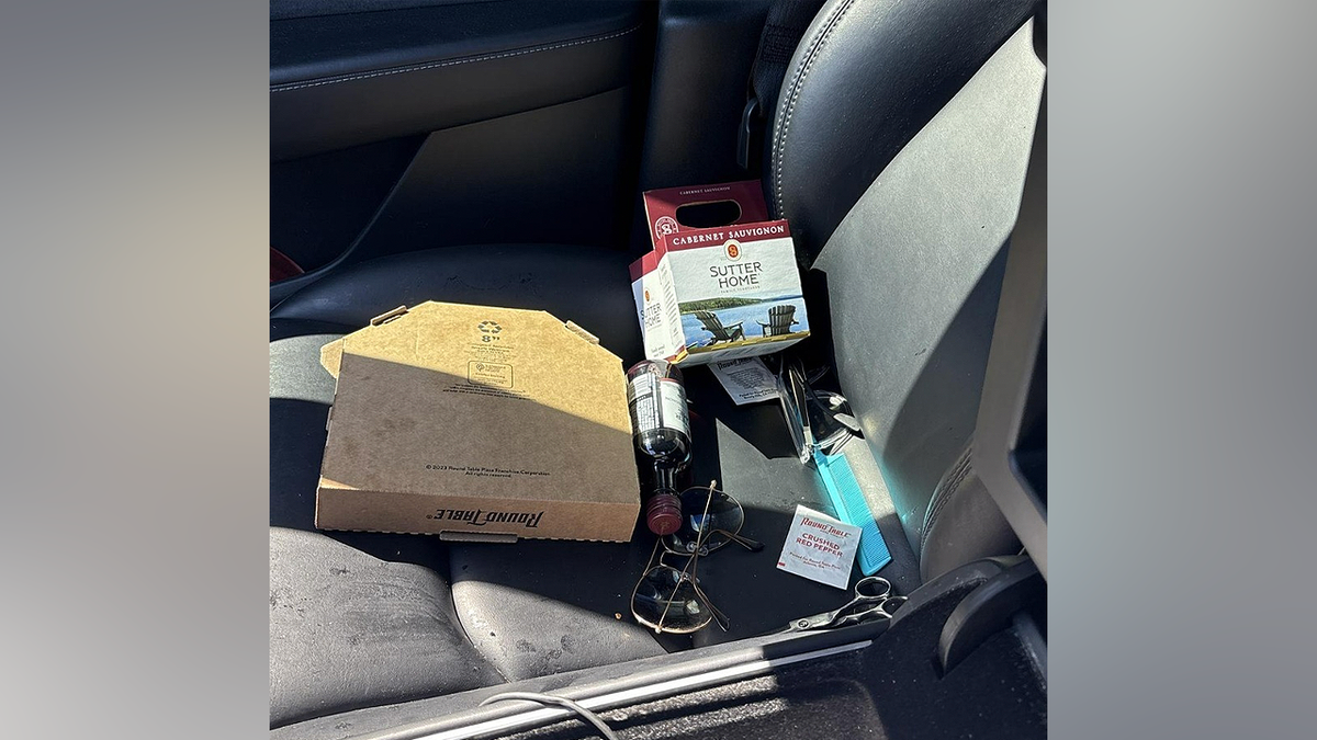 Open wine box, bottle and pizza on passenger seat in alleged DUI arrest