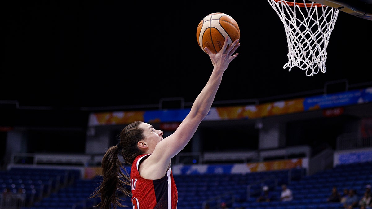 Caitlin Clark attempts a layup in a FIBA World Cup qualifier 