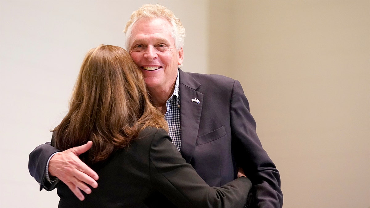 Terry McAuliffe embraces his wife, Dorothy, on stage during a campaign rally in Richmond.
