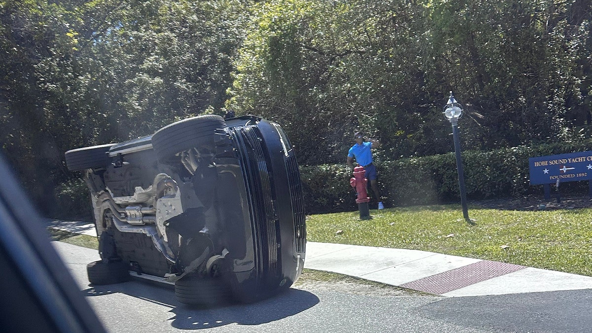 Tiger Woods stands by rolled over car