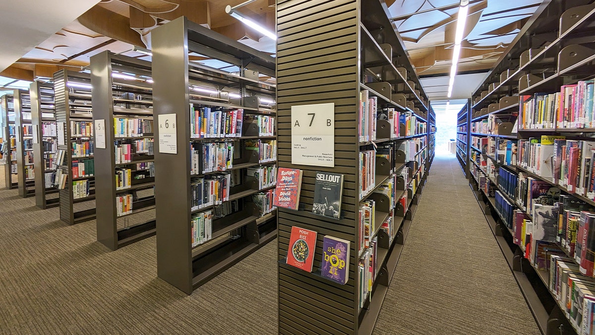 Shelves filled with nonfiction books inside the West Hollywood Library.