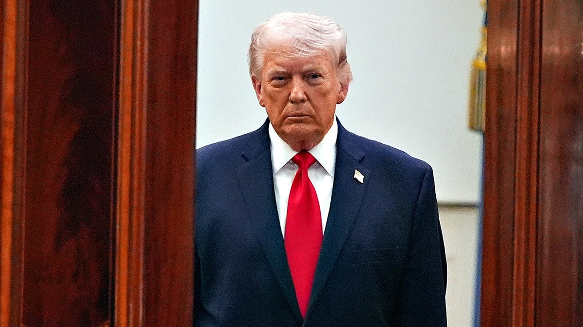 President Donald Trump walking from the Blue Room to the Cross Hall in the White House