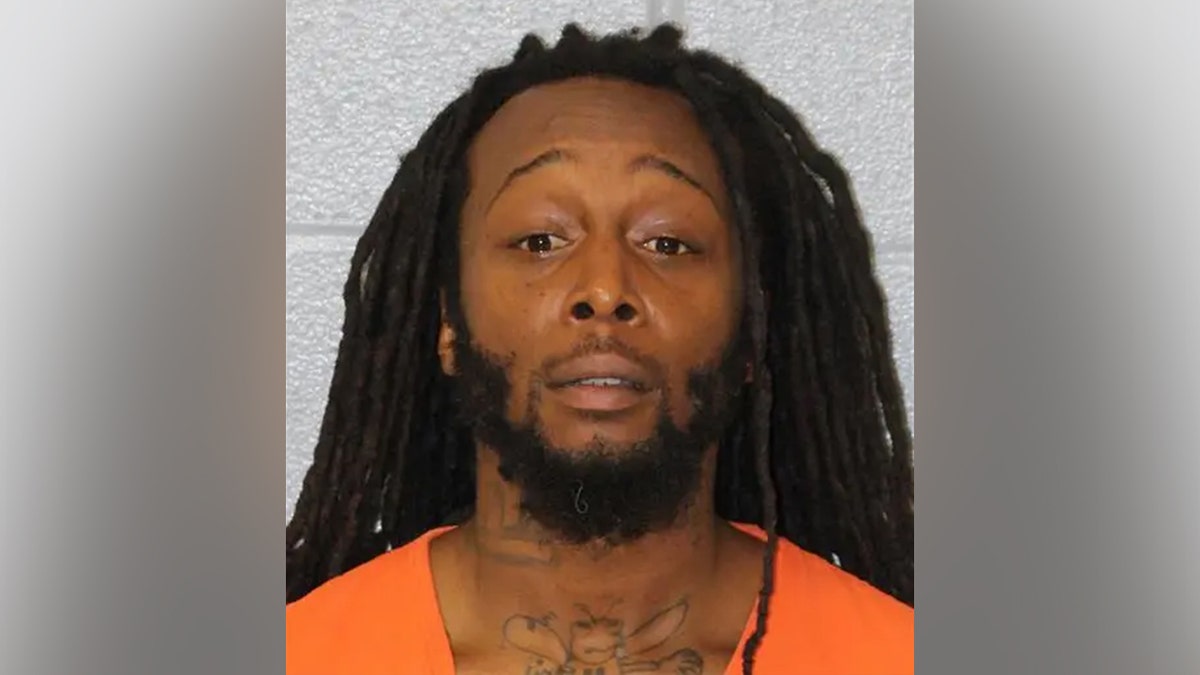 Decarlos Dejuan Brown Jr. facing camera in booking photo