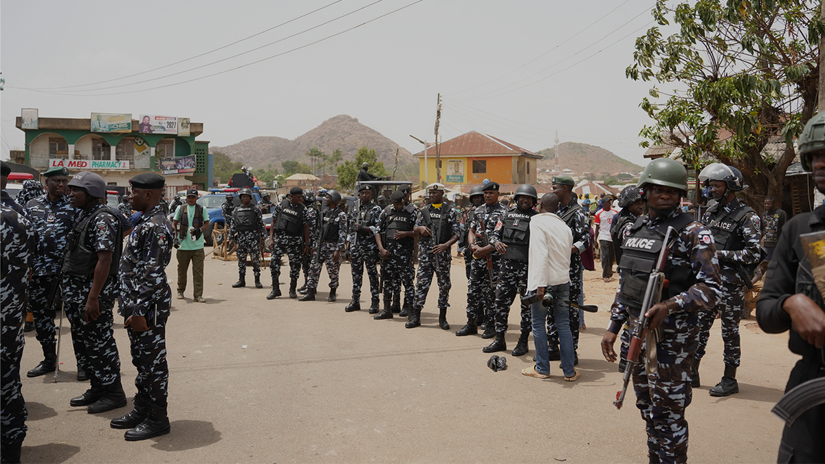 Police officers gather at the scene of a gunmen attack in Gari Ya Waye community Jos North Nigeria