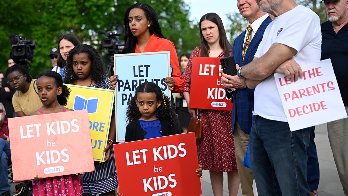 Members supporting the Opt Out policy rally outside the Supreme Court in Washington, D.C.