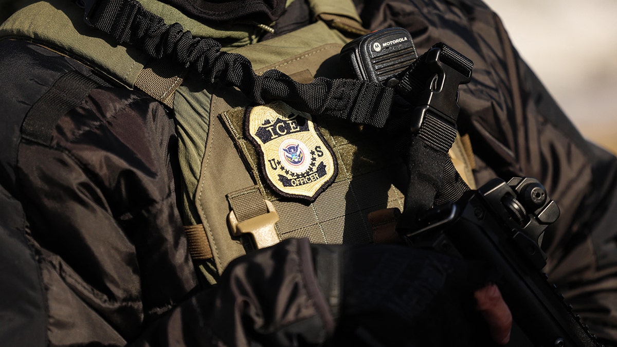 Federal agent monitoring scene near Bishop Henry Whipple Federal Building in Minneapolis