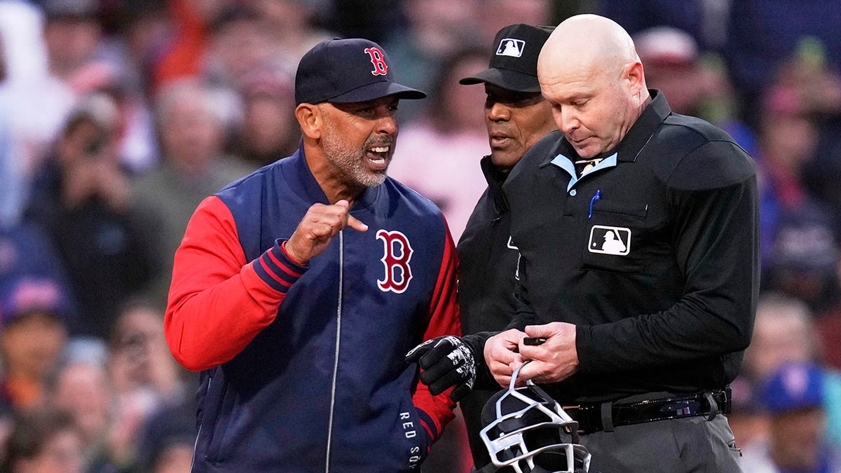 Boston Red Sox manager Alex Cora arguing with home plate umpire Mike Estabrook at Fenway Park