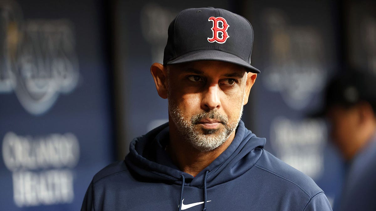 Boston Red Sox manager Alex Cora looking on from dugout at Tropicana Field