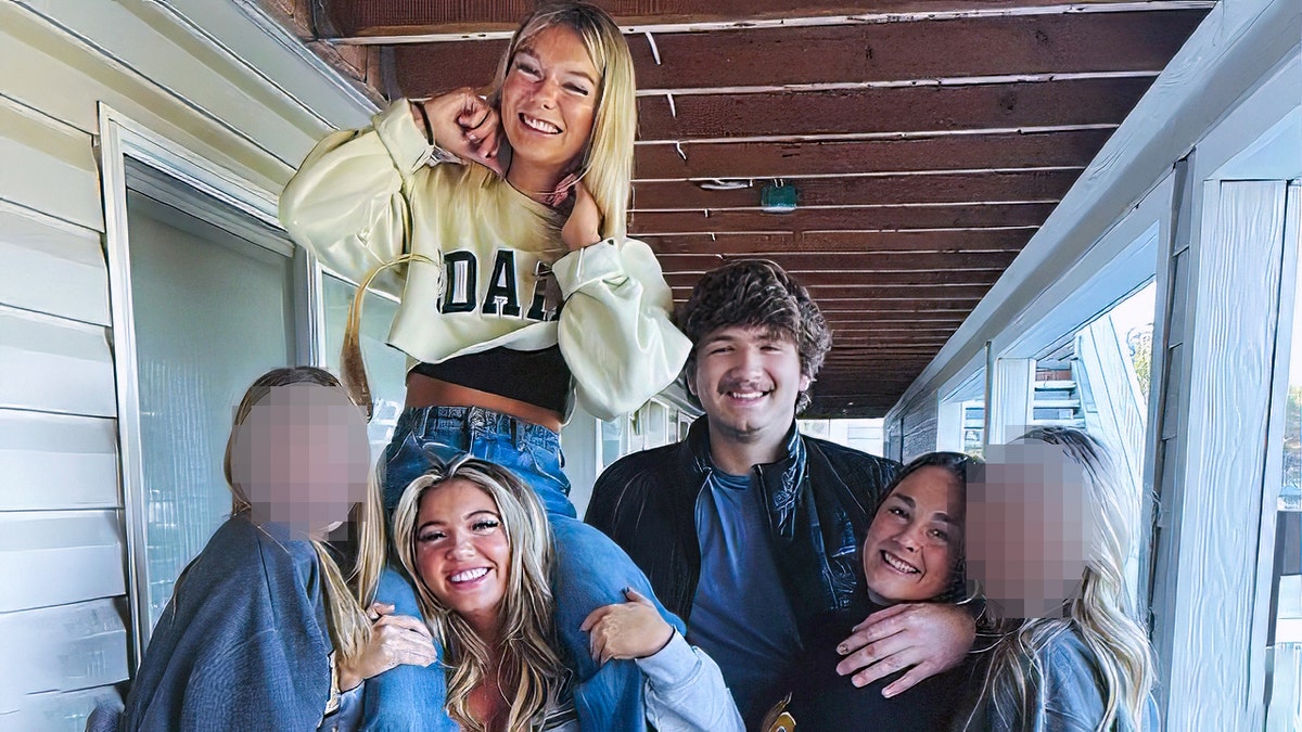 Madison Mogen smiling on Kaylee Goncalves' shoulders with Ethan Chapin, Xana Kernodle, and two other housemates posing for a photo