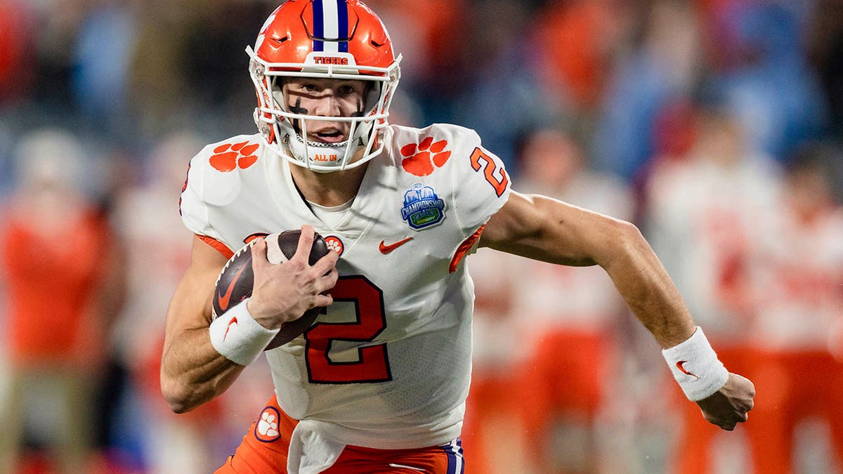 Clemson quarterback Cade Klubnik running with the football during a game.