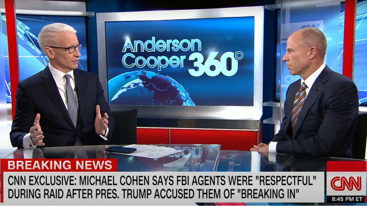 Anderson Cooper interviewing Michael Avenatti on a television set