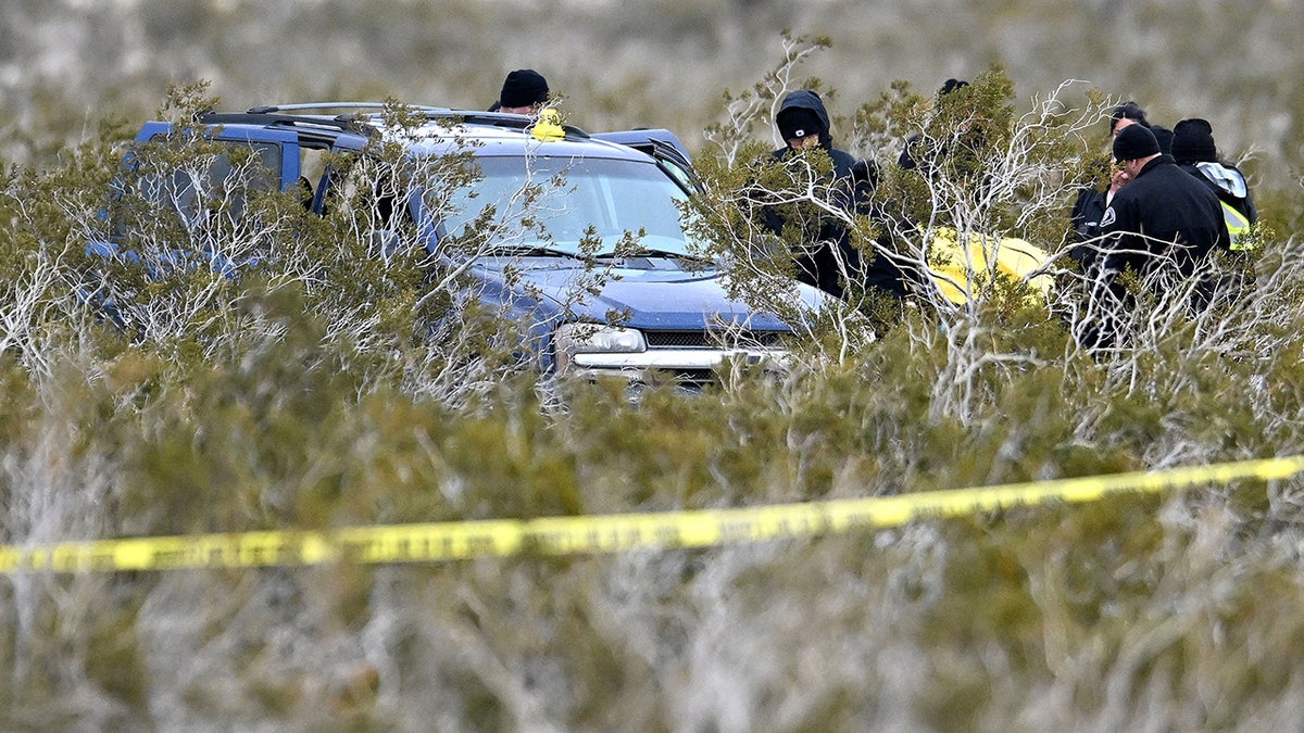 San Bernardino County Sheriff's investigators examining a remote desert road intersection