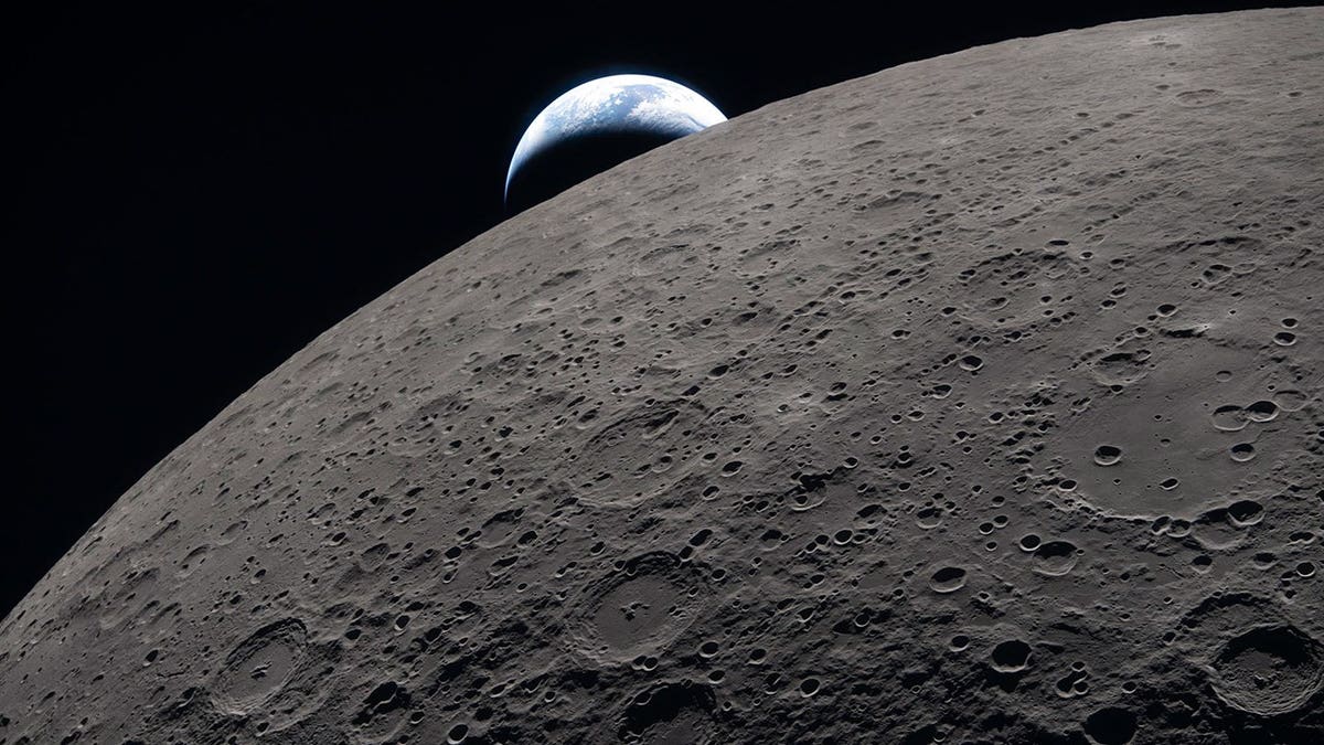 The surface of the moon in detail with the Earth in the background as captured by the crew of Artemis II on April 6, 2026.