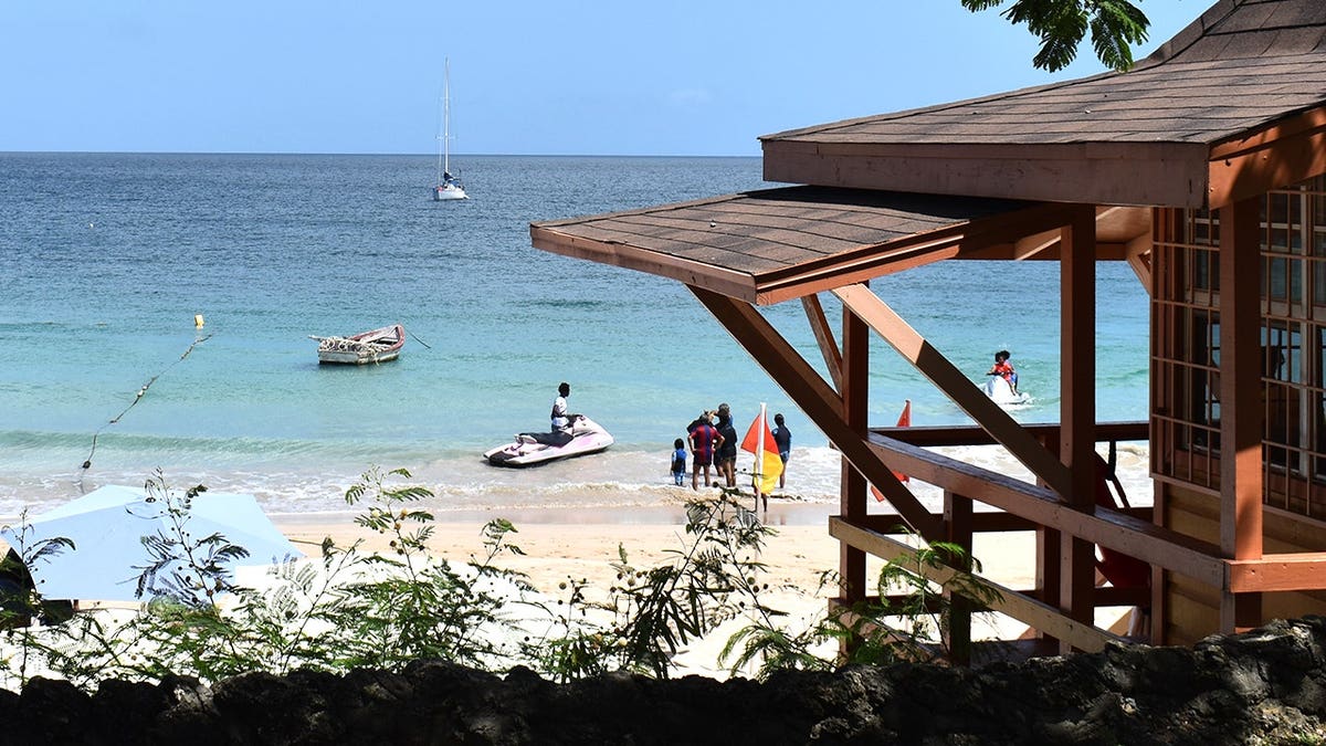 View of beach in Trinidad with tourists, swimmers