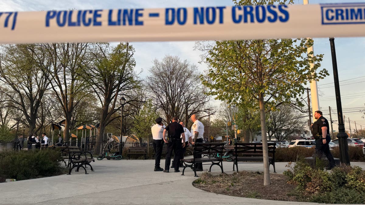 A group of police officers standing inside of a park