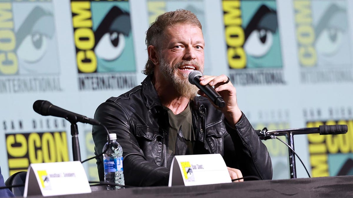 Adam Copeland speaking onstage at the Percy Jackson and the Olympians panel