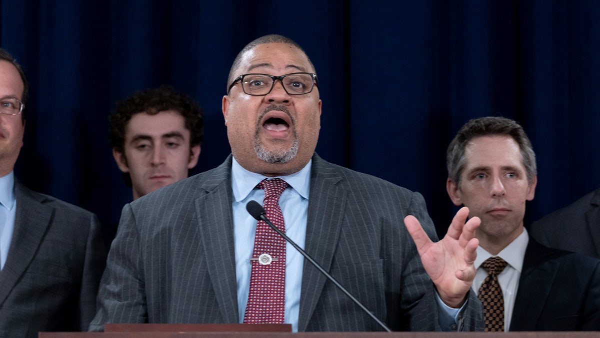 Manhattan District Attorney Alvin Bragg standing with staff at a news conference in New York City
