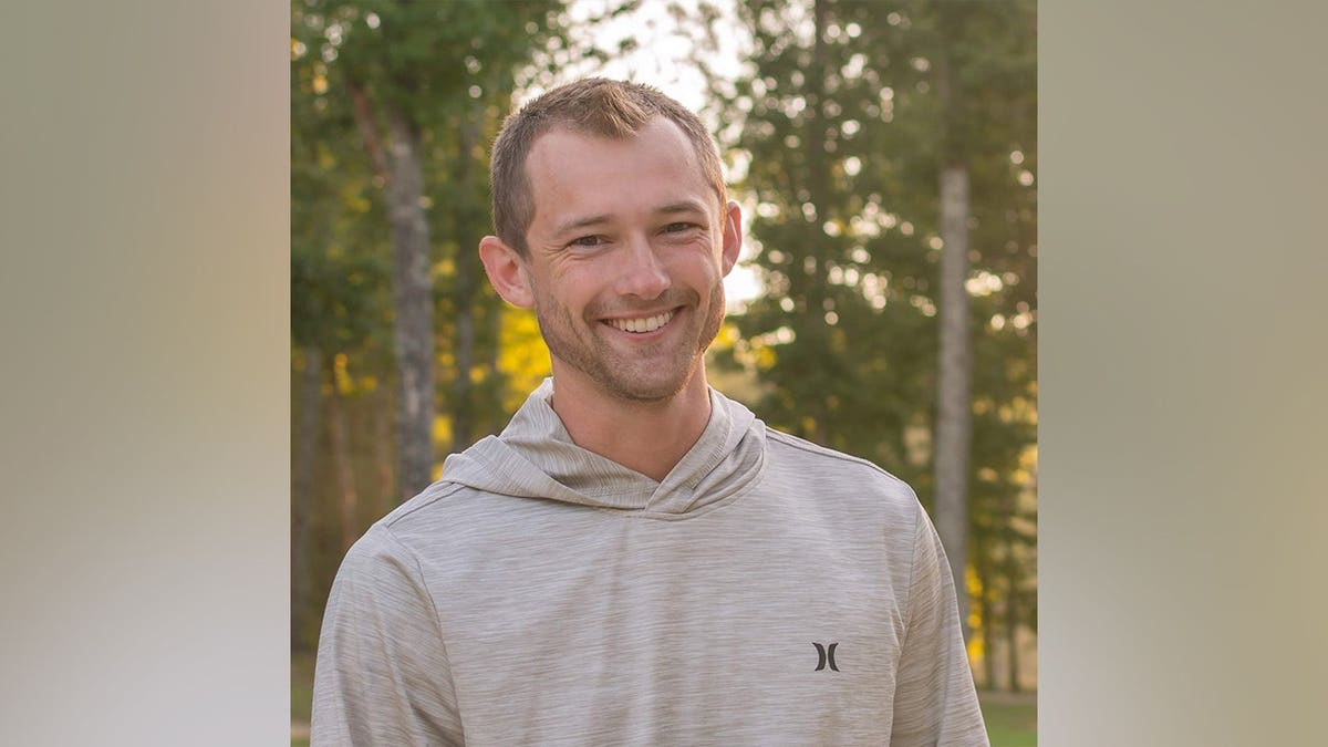 Andrew Moffatt standing and smiling in a casual setting