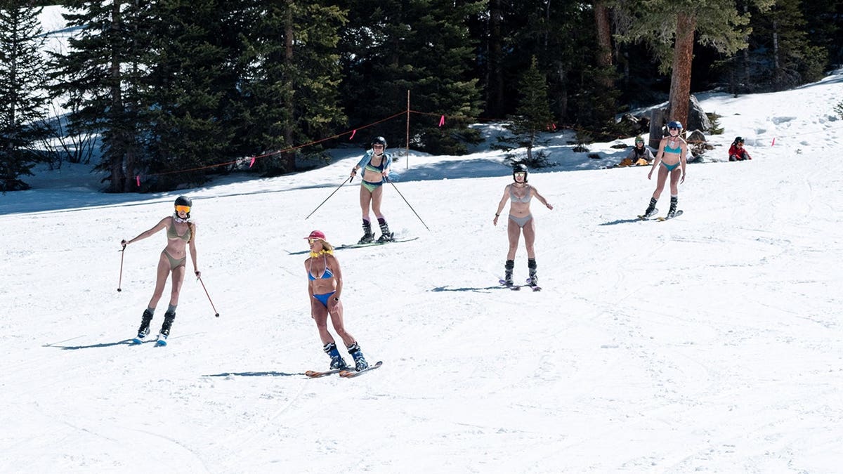 A group of friends skiing in swimsuits at Arapahoe Basin Ski Resort in Colorado