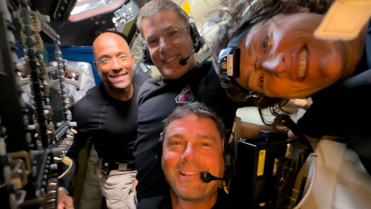 Artemis II crew members Victor Glover, Jeremy Hansen, Reid Wiseman and Christina Koch taking a selfie during lunar flyby