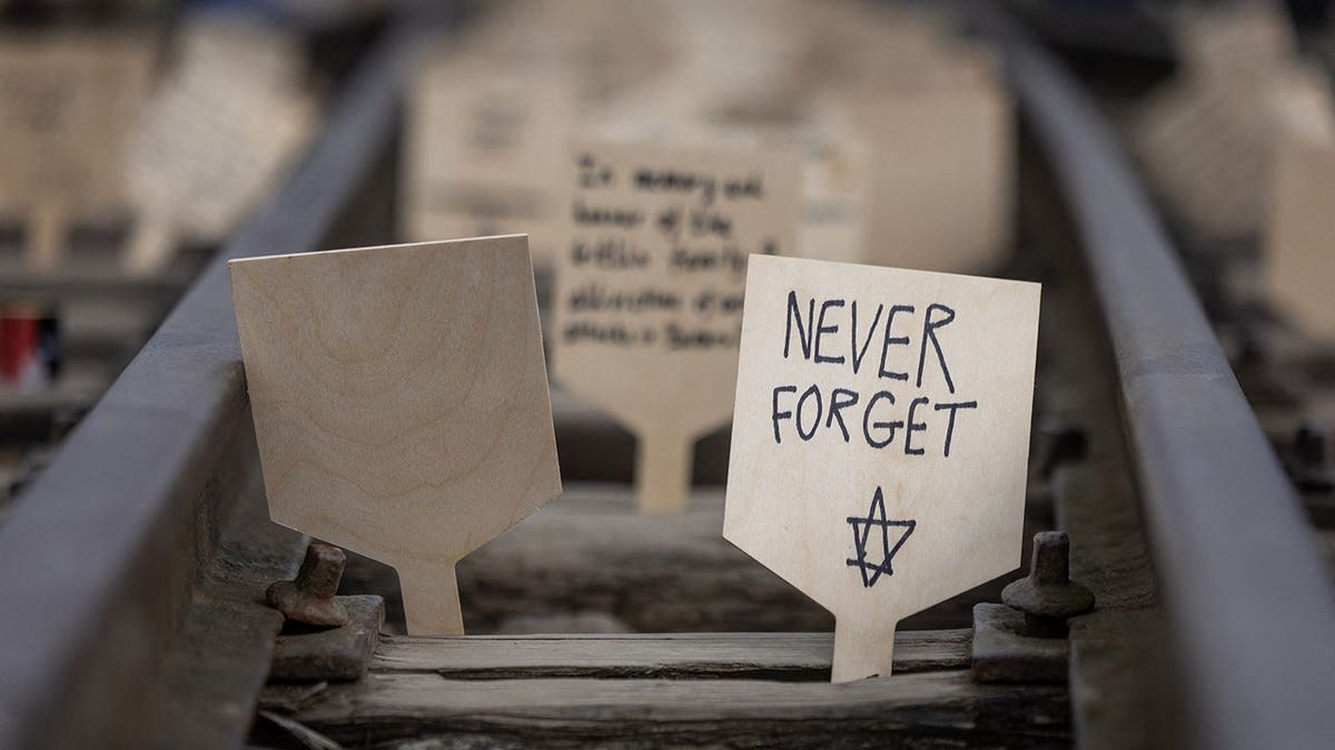 Commemorative plaques on railtrack leading to Auschwitz-Birkenau death camp site in Poland