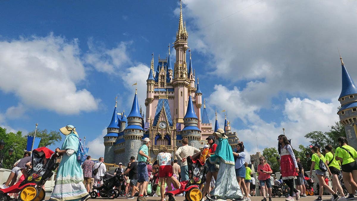 Guests walking near Cinderella Castle at Magic Kingdom in Walt Disney World