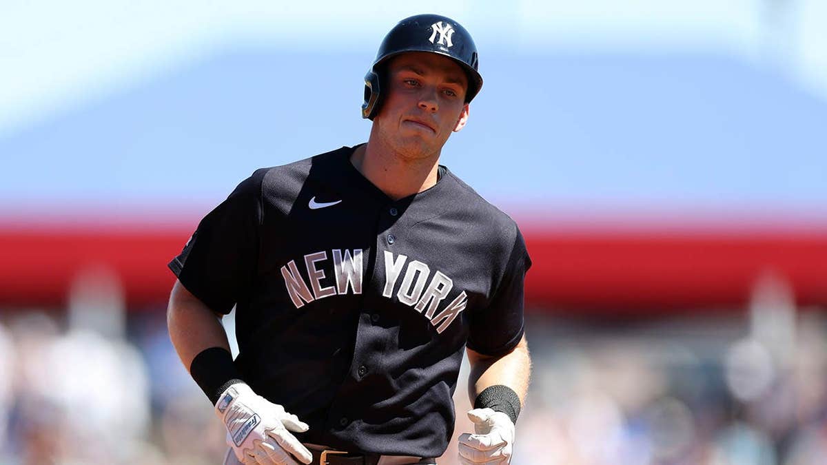 Ben Rice running the bases after hitting a home run during a baseball game.