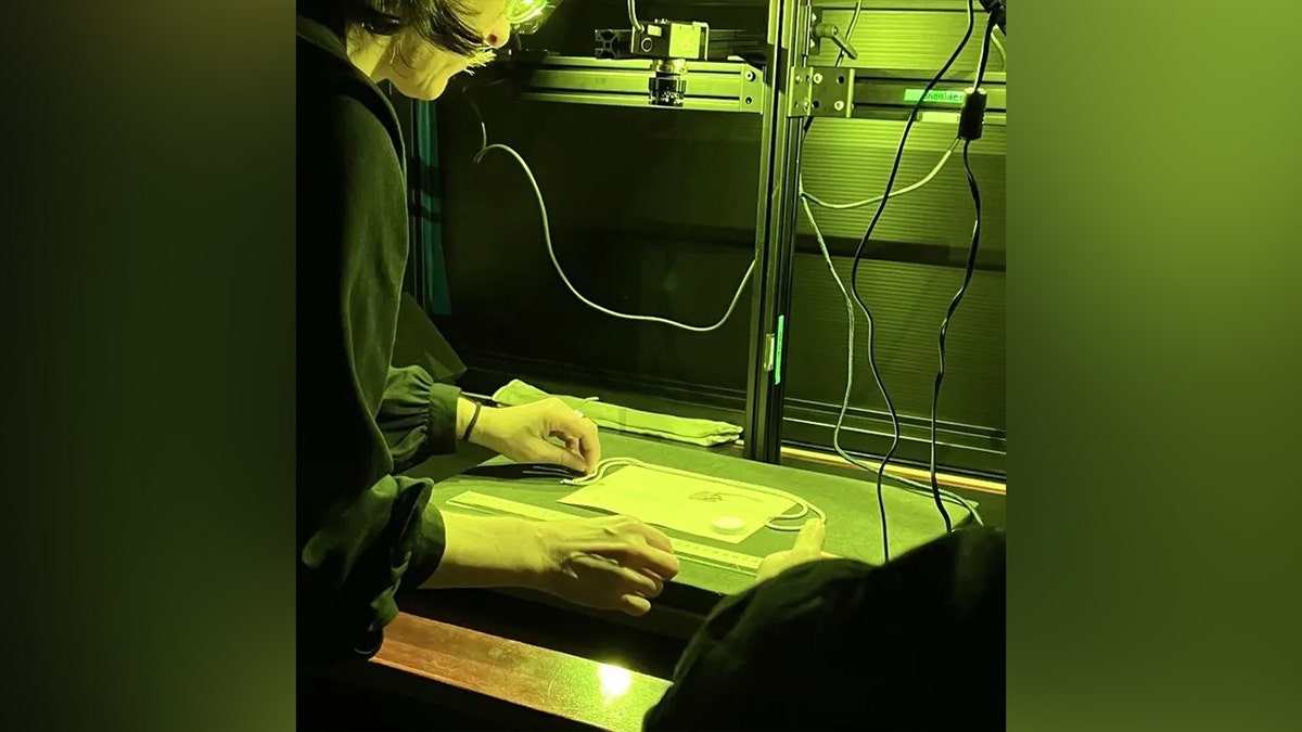 Dr. Stephanie Lahey scans a piece of material with the MISHA