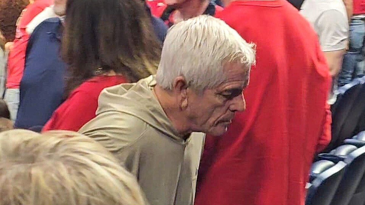 Chris Nanos leaving his seat at a basketball game