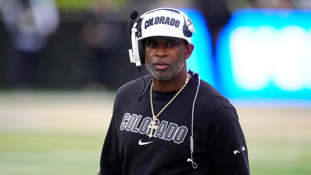 Colorado Buffaloes head coach Deion Sanders standing on the sideline at Folsom Field.