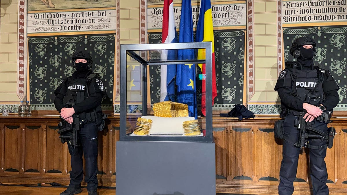 Police officers standing by the 2,500-year-old Cotofenesti helmet during a press conference in Assen Netherlands
