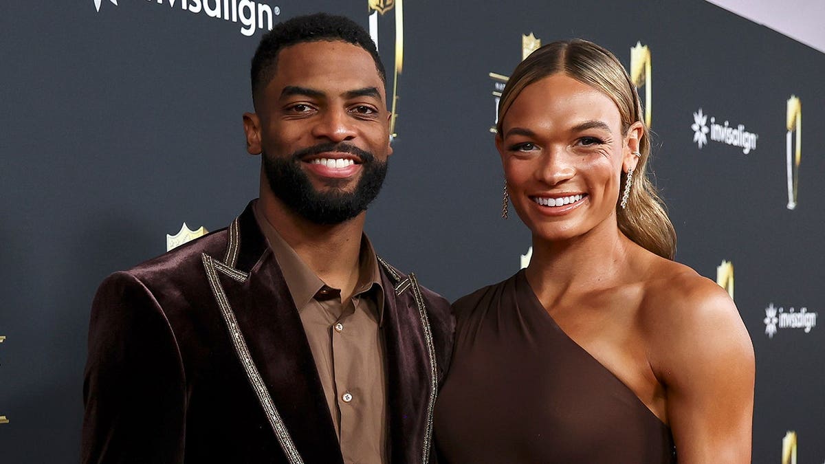 Darius Slayton and Anna Hall posing on the red carpet at Saenger Theatre
