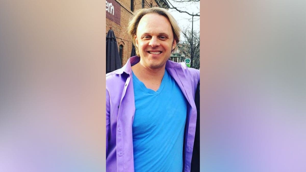 David Wilcock in front of a dark background