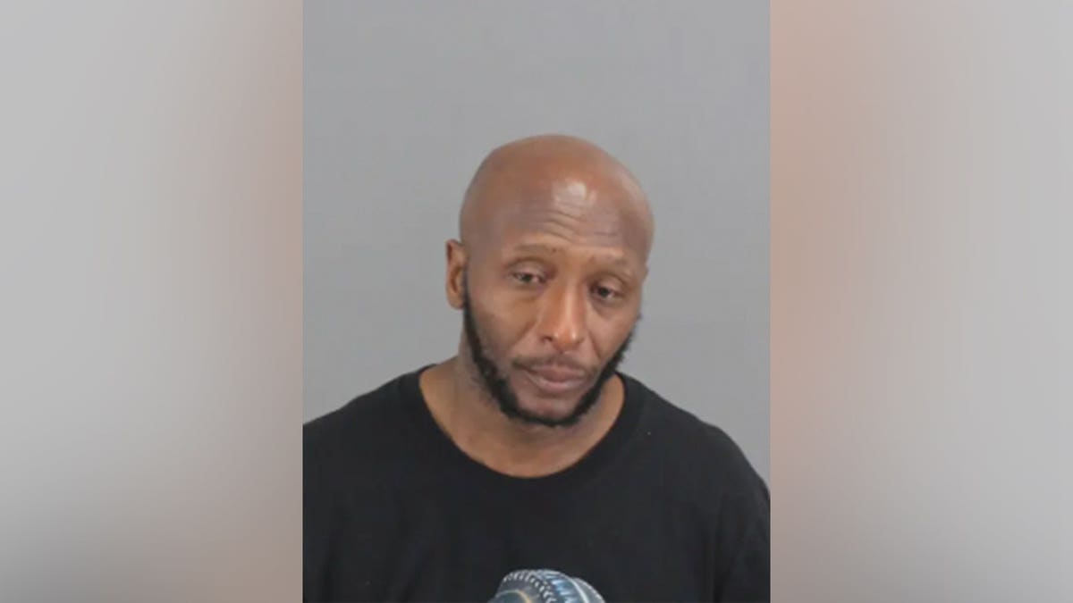 Donald James Fields standing in a police mugshot photo