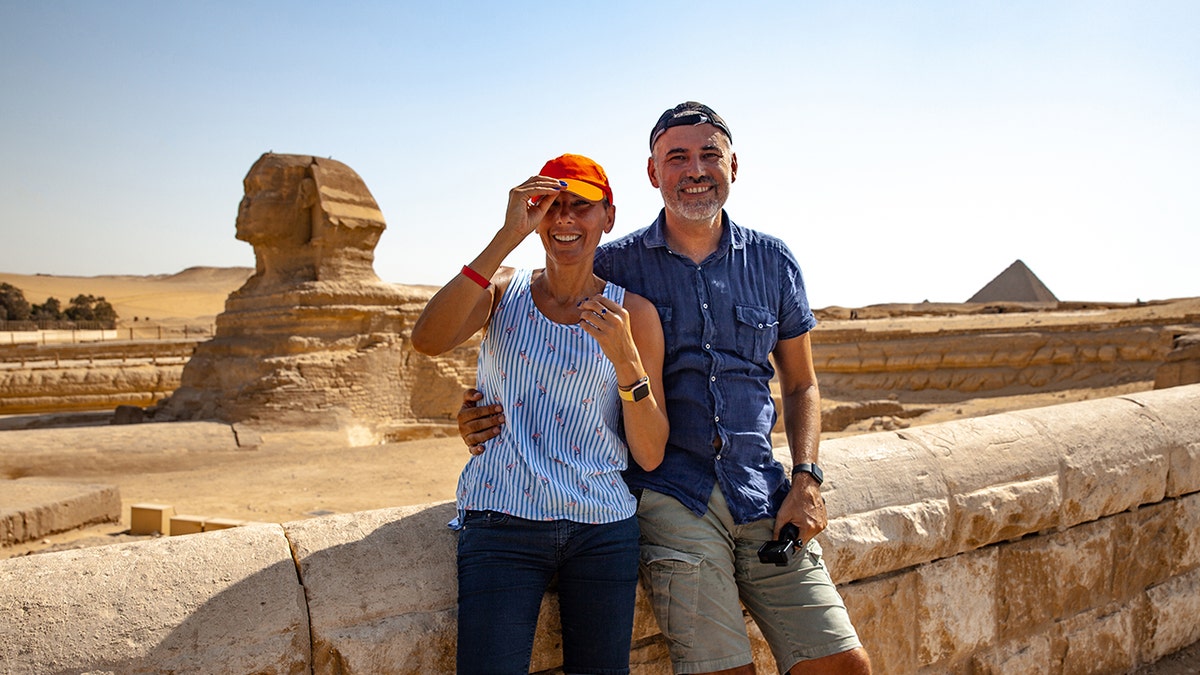 Middle aged couple smiling near egypt landmark