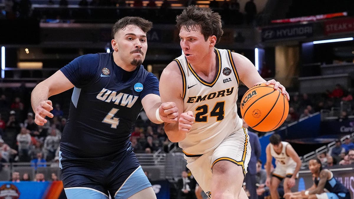 Emory Eagles forward AJ Harris dribbling basketball against Mary Washington Eagles guard Hasan Hammad