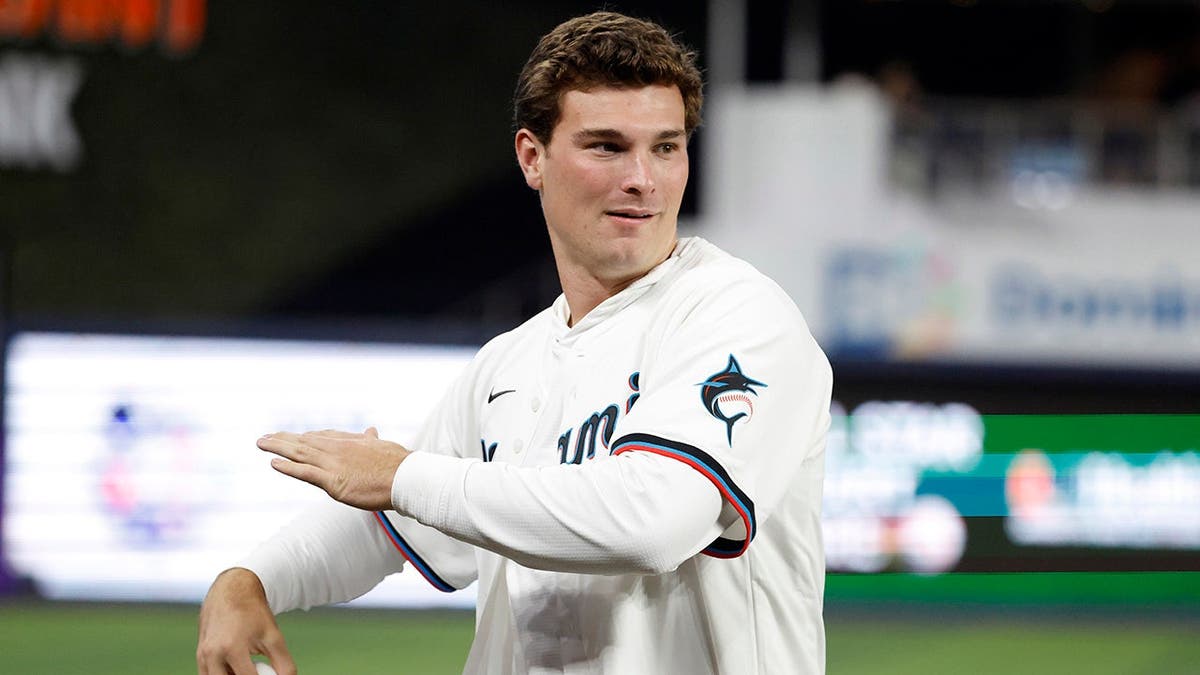Indiana Hoosiers quarterback Fernando Mendoza throws a ceremonial first pitch at loanDepot Park in Miami