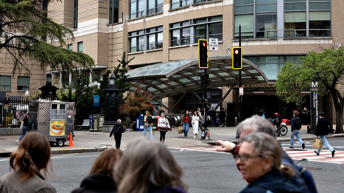 Foggy Bottom metro station platform with train and passengers.