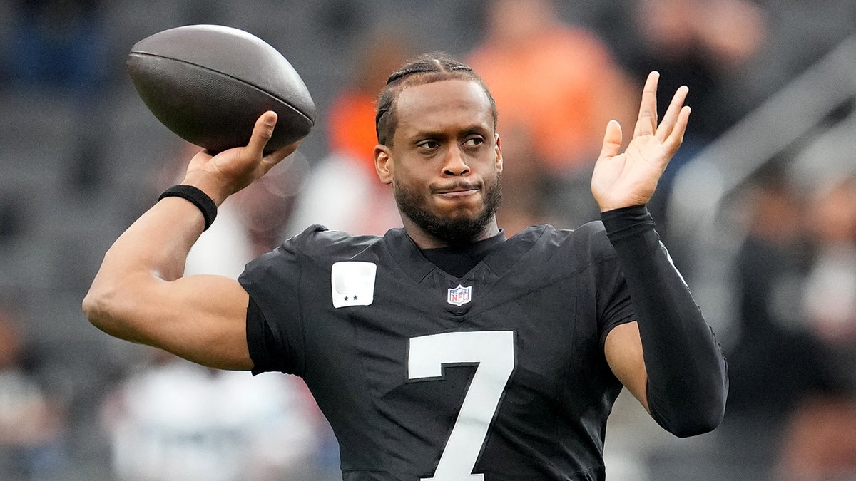 Las Vegas Raiders quarterback Geno Smith warming up on the field at Allegiant Stadium