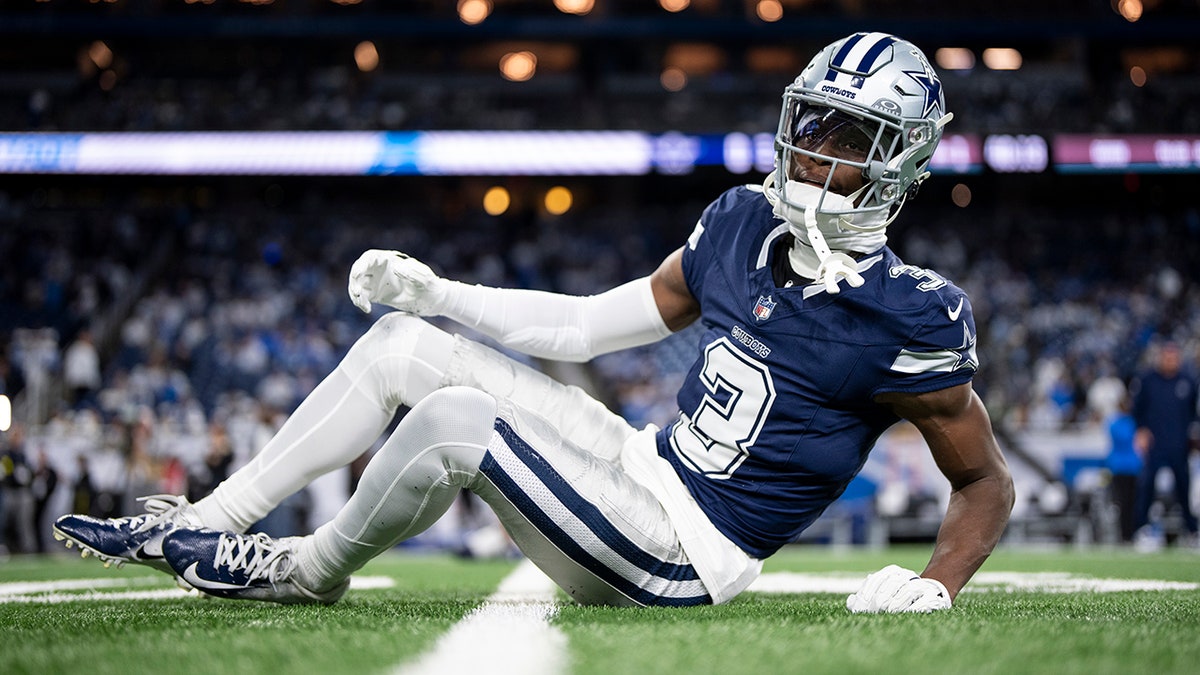 George Pickens of the Dallas Cowboys stretching on the field at Ford Field in Detroit
