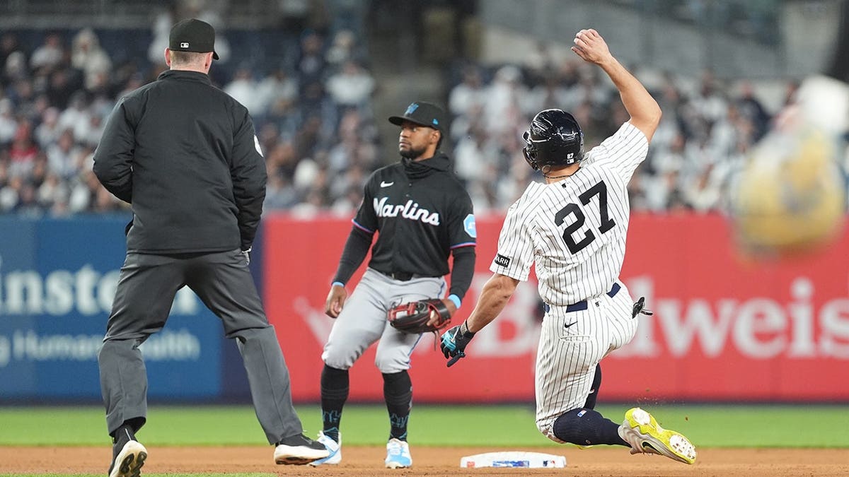 New York Yankees designated hitter Giancarlo Stanton stealing second base at Yankee Stadium