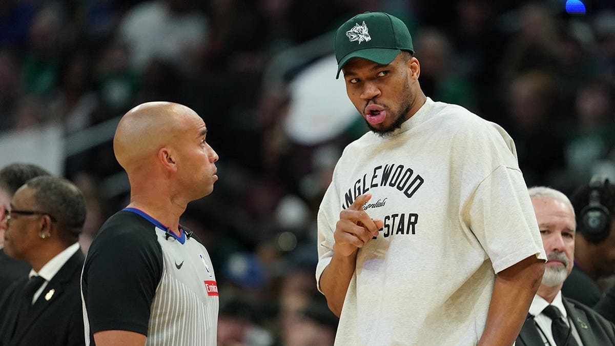 Giannis Antetokounmpo talking with an official during an NBA game in Milwaukee