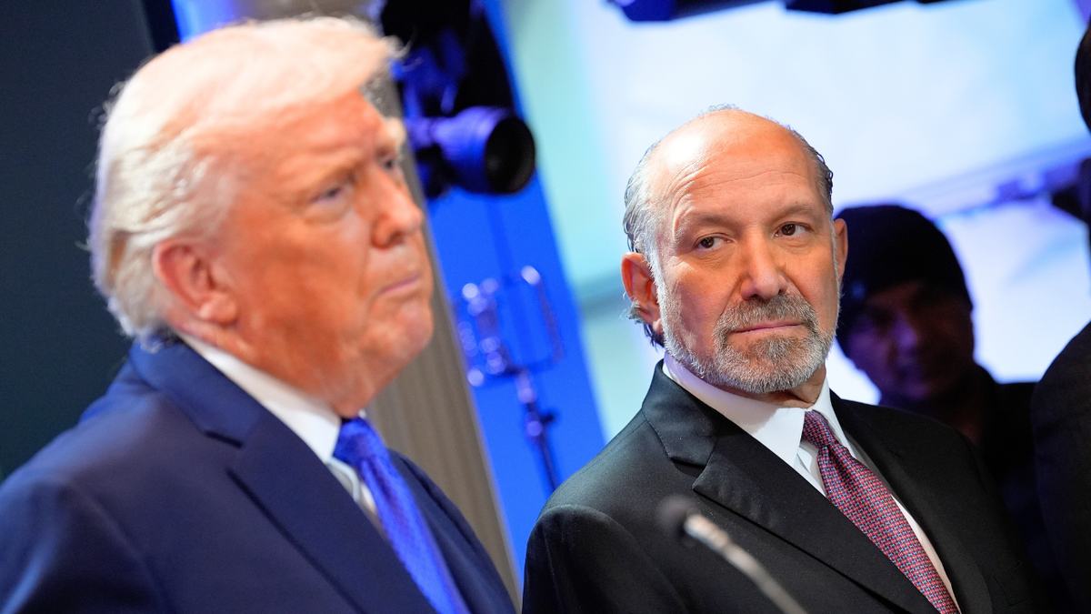 US Commerce Secretary Howard Lutnick and President Donald Trump are seen during a White House press briefing.